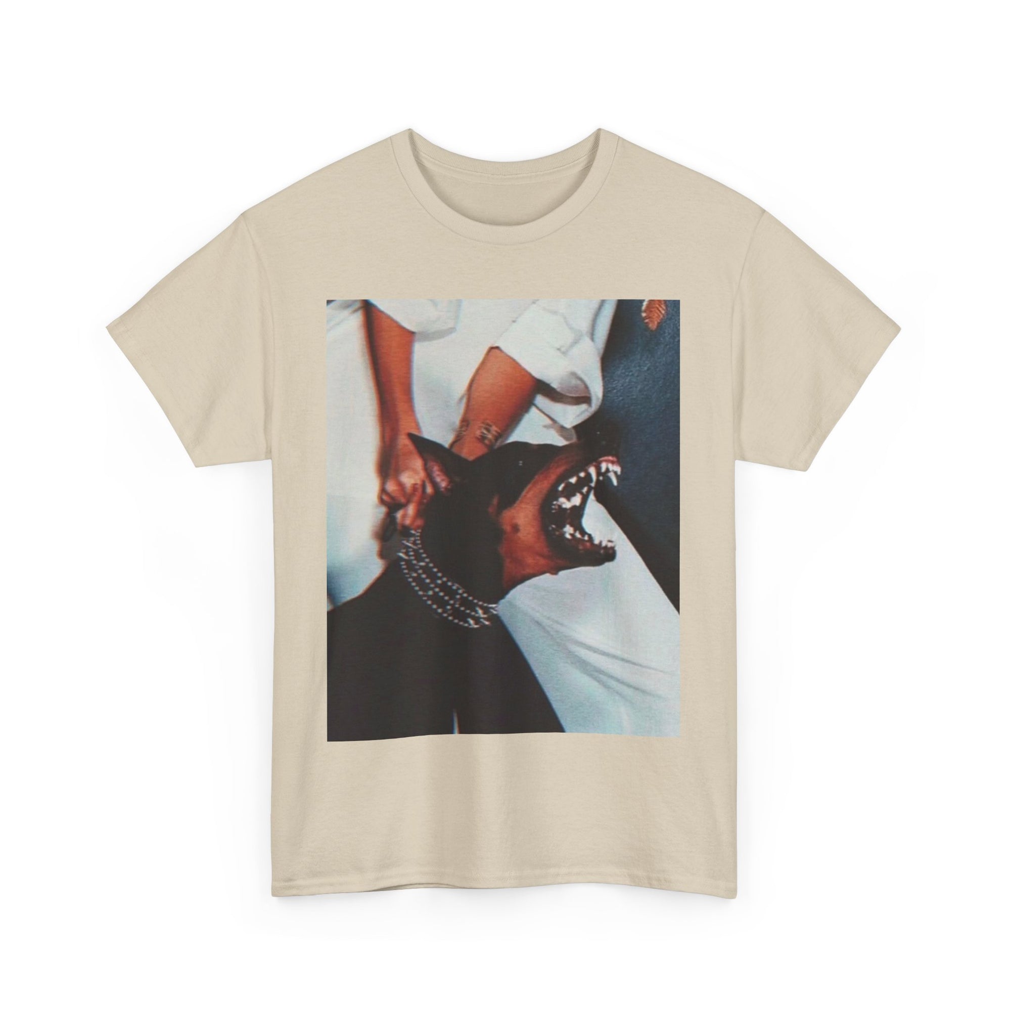 Beige t-shirt with a graphic of a woman holding back a doberman 