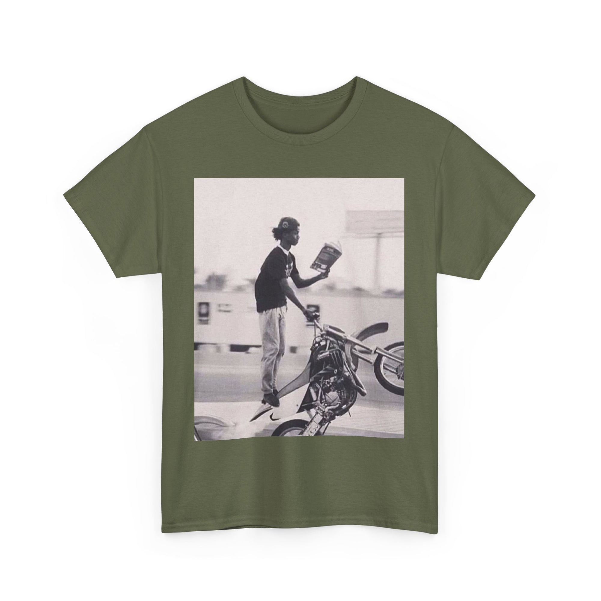 Green t-shirt with a graphic of a person wheeling on a motorcycle and reading a book.