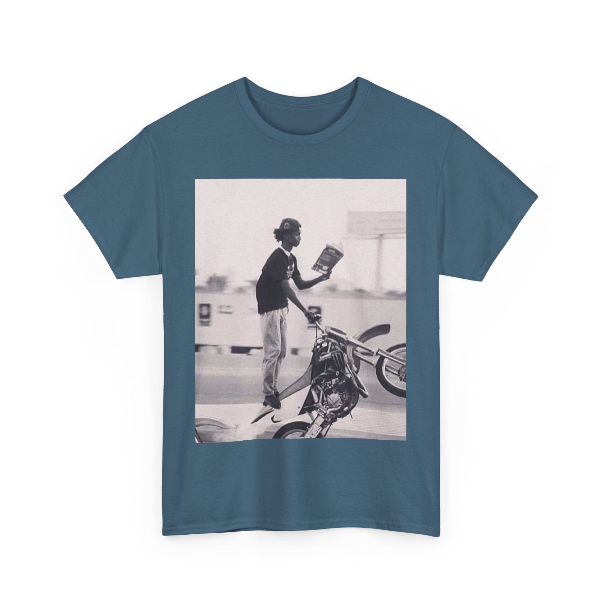 Blue t-shirt with a graphic of a person on a motorcycle and book on a white background